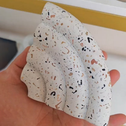 Terrazzo-patterned fan-shaped bookshelf