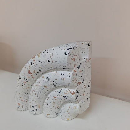 Terrazzo-patterned fan-shaped bookshelf