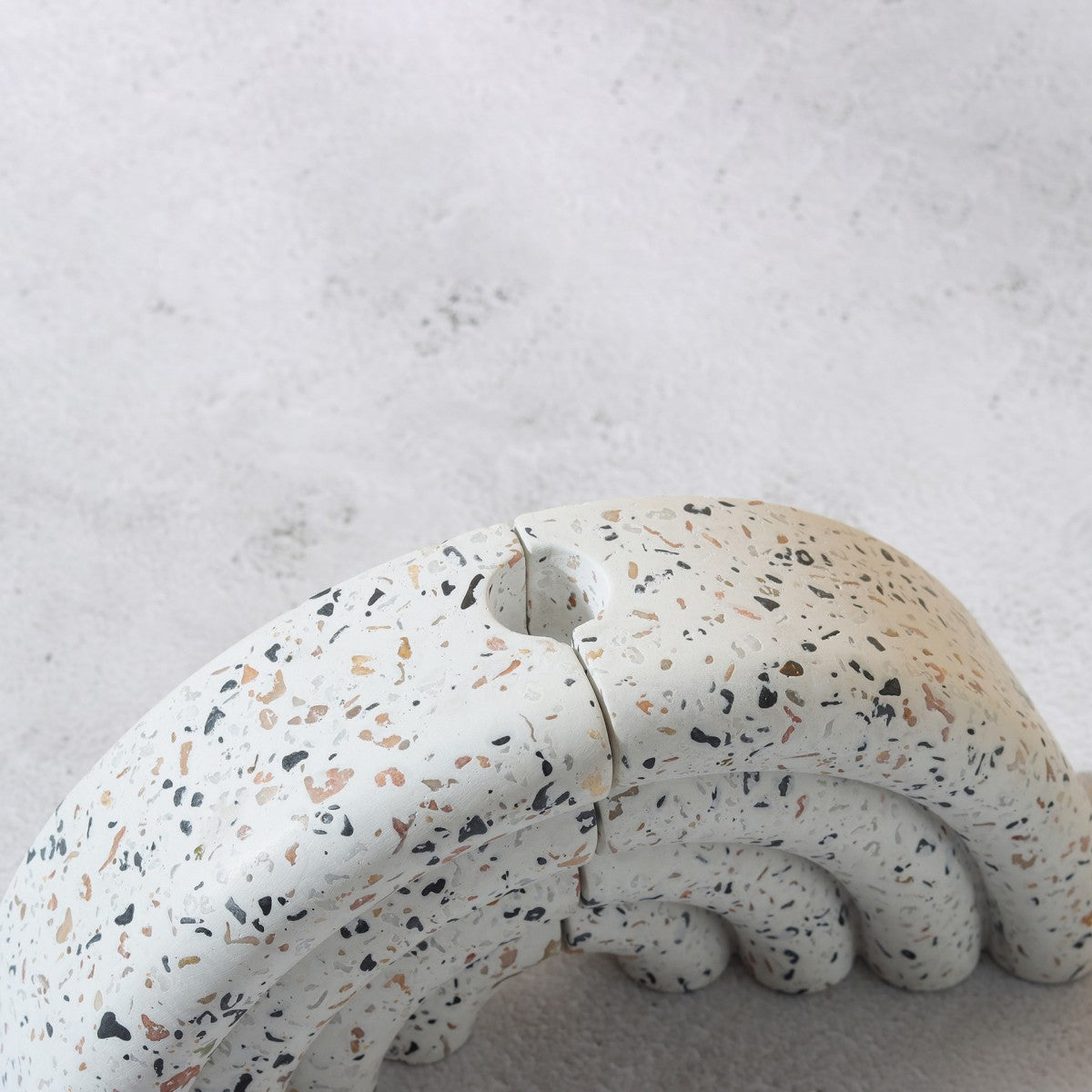 Terrazzo-patterned fan-shaped bookshelf